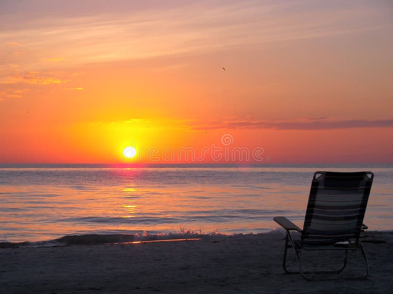 Beach chair. Chair on the florida beach at sunset royalty free stock photography