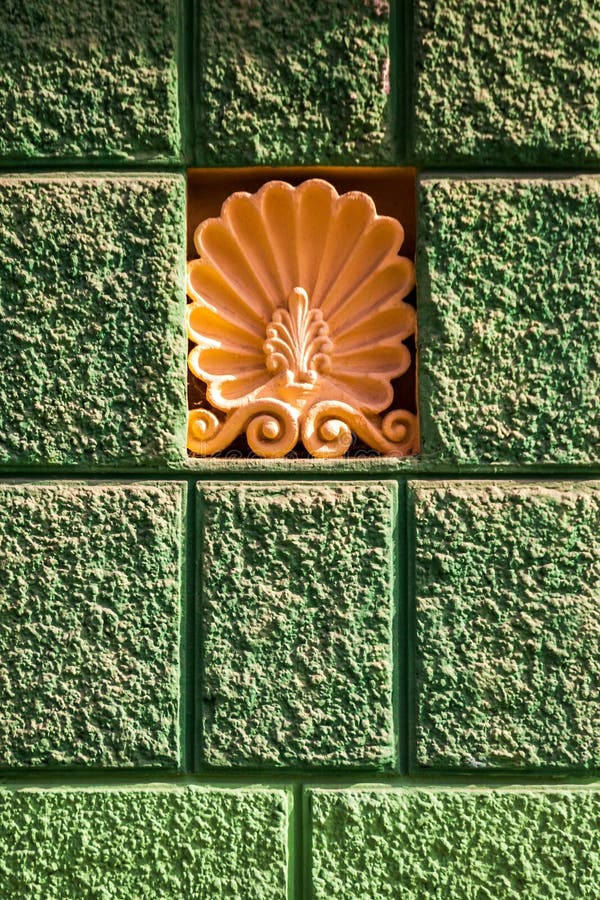 Beautiful stucco molding in the form of a flower. On the wall of an apartment building royalty free stock photo