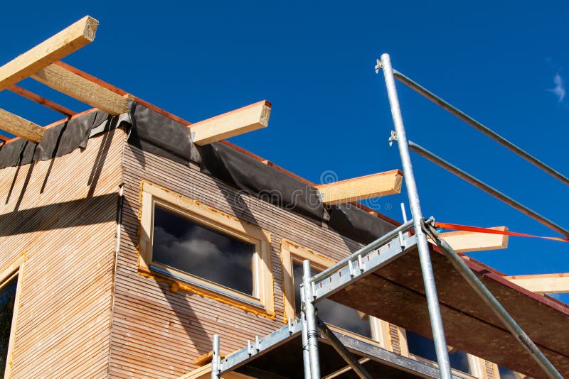 Construction of a wooden roof in an ecological house. External work on the building envelope. The wooden structure of the house ne royalty free stock images