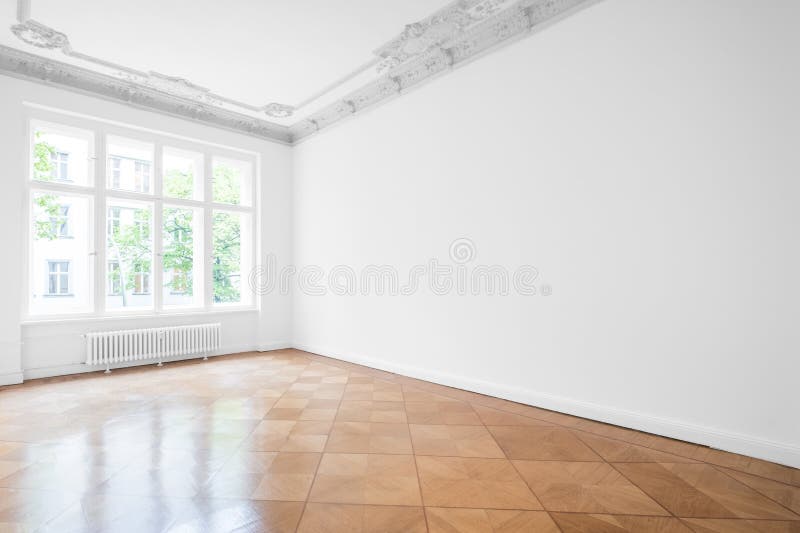Empty room with parquet floor , white walls and stucco ceiling. New renovated flat in old building royalty free stock photos
