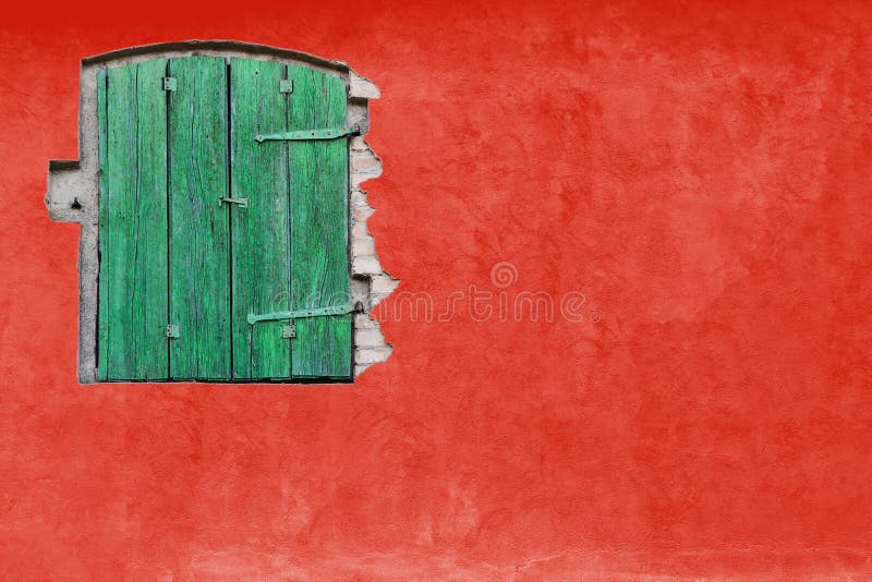 Green window on red stucco wall. Vivid bright red colour house home facade with green wooden window. And large empty red wall texture empty background space royalty free stock photography