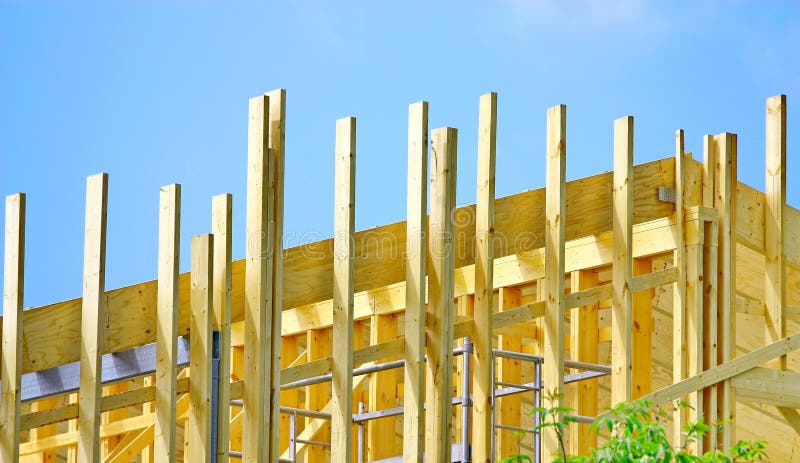Home Construction. Wooden house frame against blue sky royalty free stock images