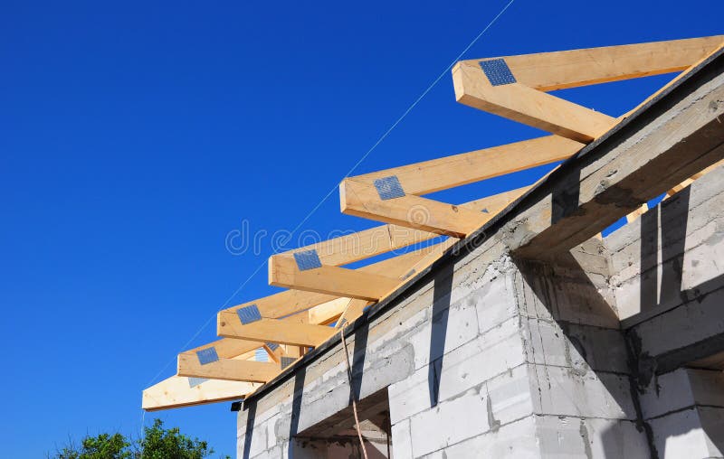 Installation of wooden beams at construction the roof truss system of the house royalty free stock photos
