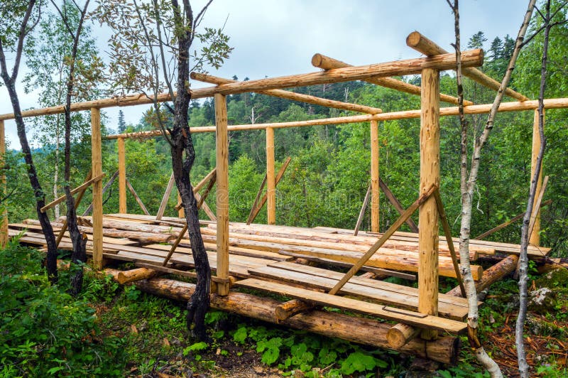 Installation of wooden beams from logs stock images