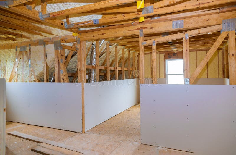 Inside attic roof andwall insulation in wooden house, building under construction stock photos