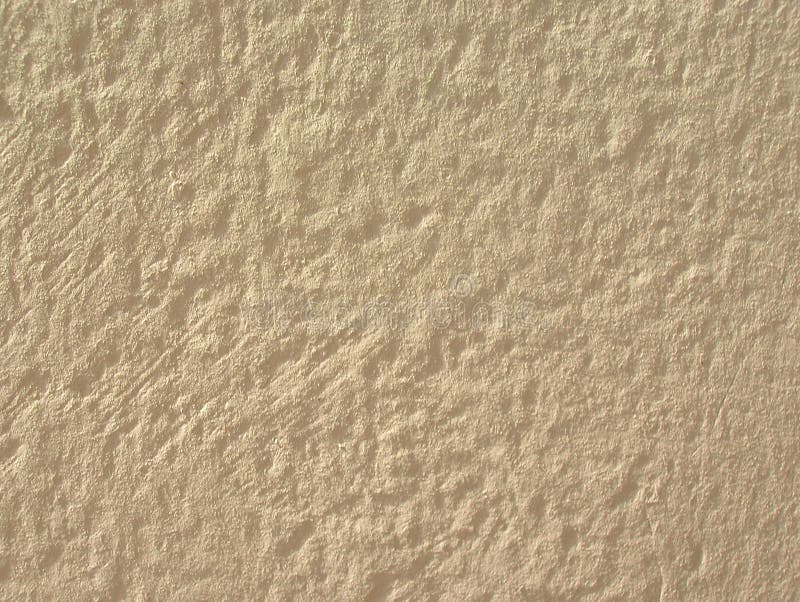 Light stucco. Rough shaggy stucco wall of a light cream colour stock photography