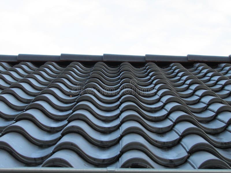Metal roof tile. Roof tile in line. Row of black tile. royalty free stock image