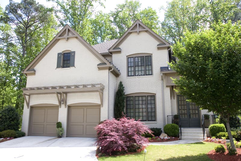 Nice Brown Stucco House. A nice house of brown stucco on a landscaped lawn stock photos