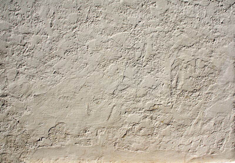 Old stucco wall texture of beige color. Grunge background with old stucco wall texture of beige color stock photo