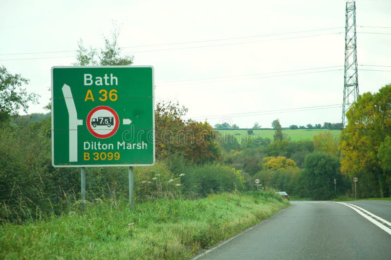 Road sign scene. WEST SUSSEX, ENGLAND - OCT, 18: Dual carriage way to bath with traditional sign maximum load weight warning for purpose of road safety for stock photos