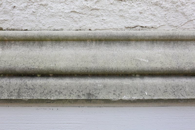 Stucco Concrete Wall with Old Cement Molding in Center. Stone, stucco wall with old cement molding. This is a great picture for text on all thirds. A great royalty free stock images