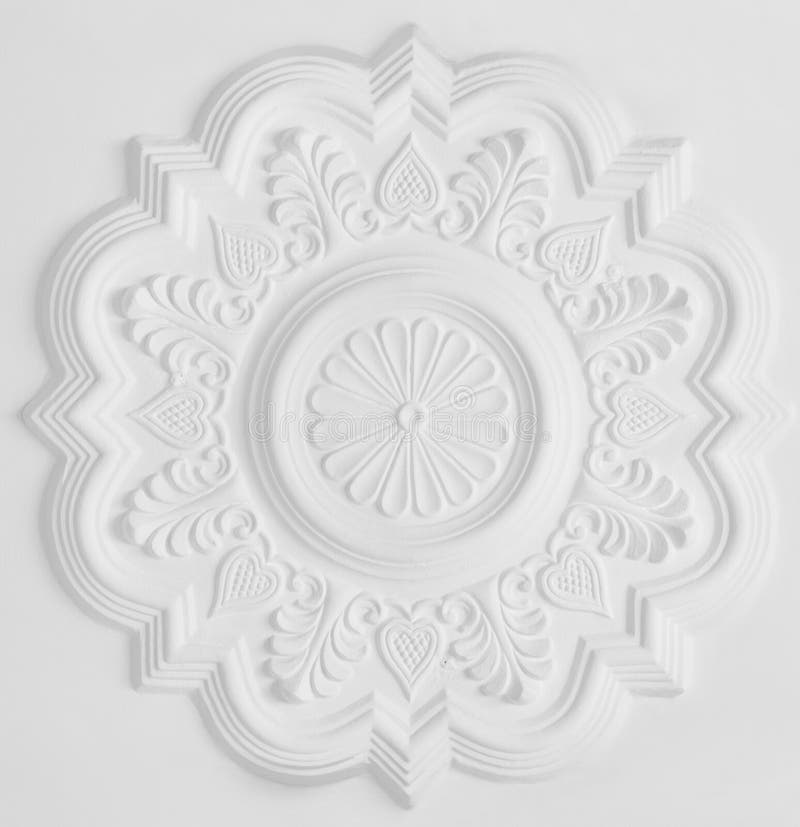 Stucco moulding rosette. Floral stucco moulding rosette on white ceiling stock photo