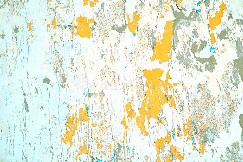 Textured stucco background - light beige peeling stucco and bright orange peeling paint. With blue streaks on the aged rough wall surface royalty free stock images