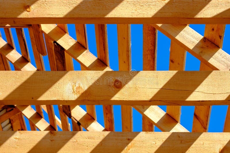 Unfinished wooden roof against the blue sky royalty free stock images