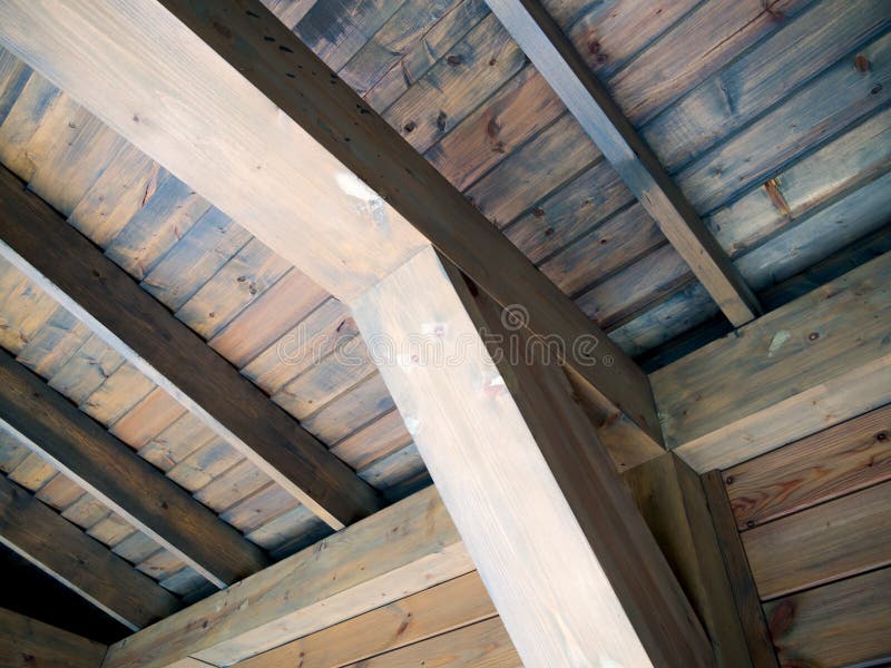 Wooden support beam and roof lathing riveted to it stock images