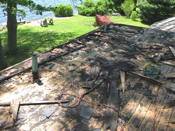 Rotten wood damage to decking and rafters on a flat roof in Andover, CT