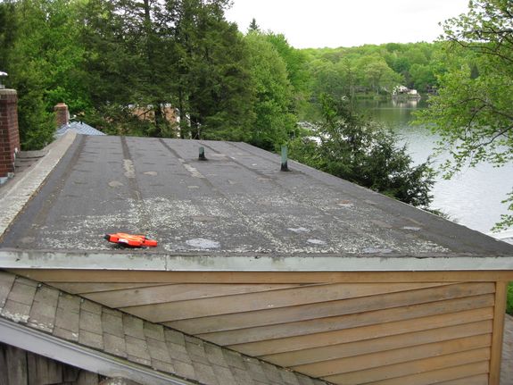 This lake front home in Andover, Connecticut has a rolled asphalt roof that has been patched multiple times and still leaks.