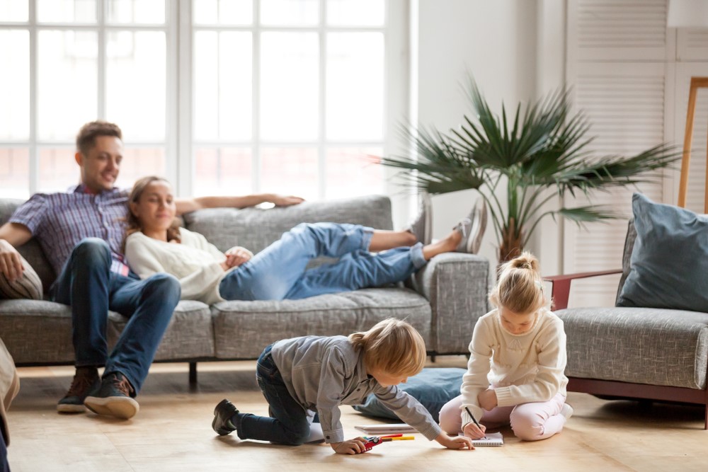 Children Playing While Parents Watch Sitting on the Couch