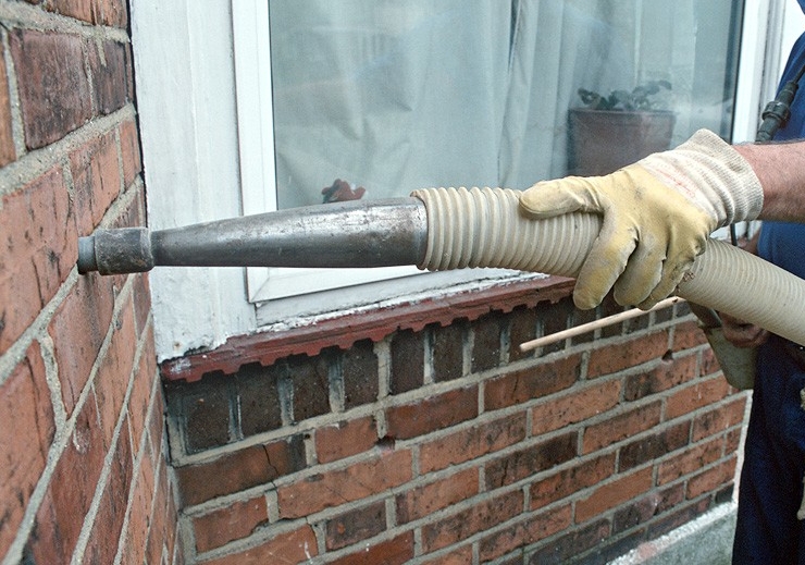 Cavity walls being Injected